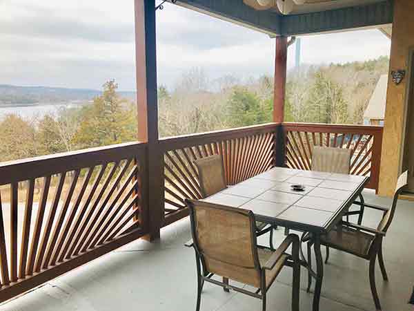 a table and chairs on a covered porch